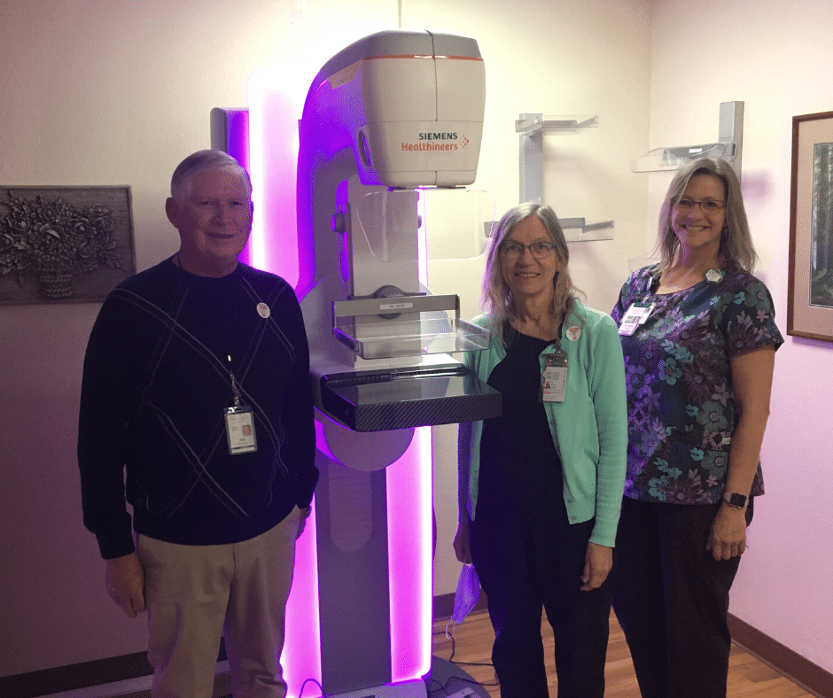 Hospital Staff members next to a Mammography machine